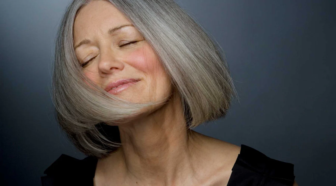 Beautiful woman with grey hair smiling